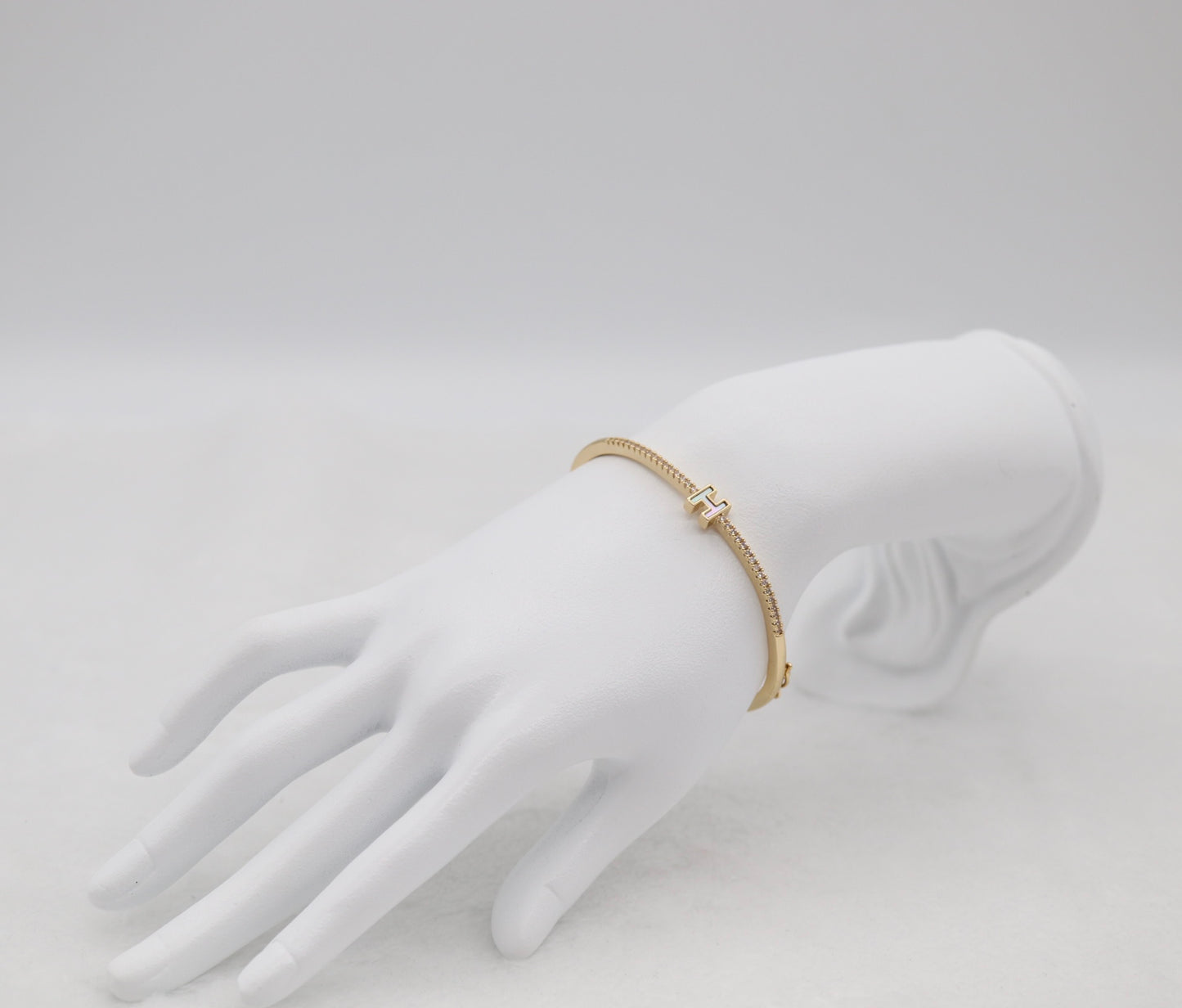 Gold-Tone Hinged Bangle with Crystal Accents and “H” Centerpiece