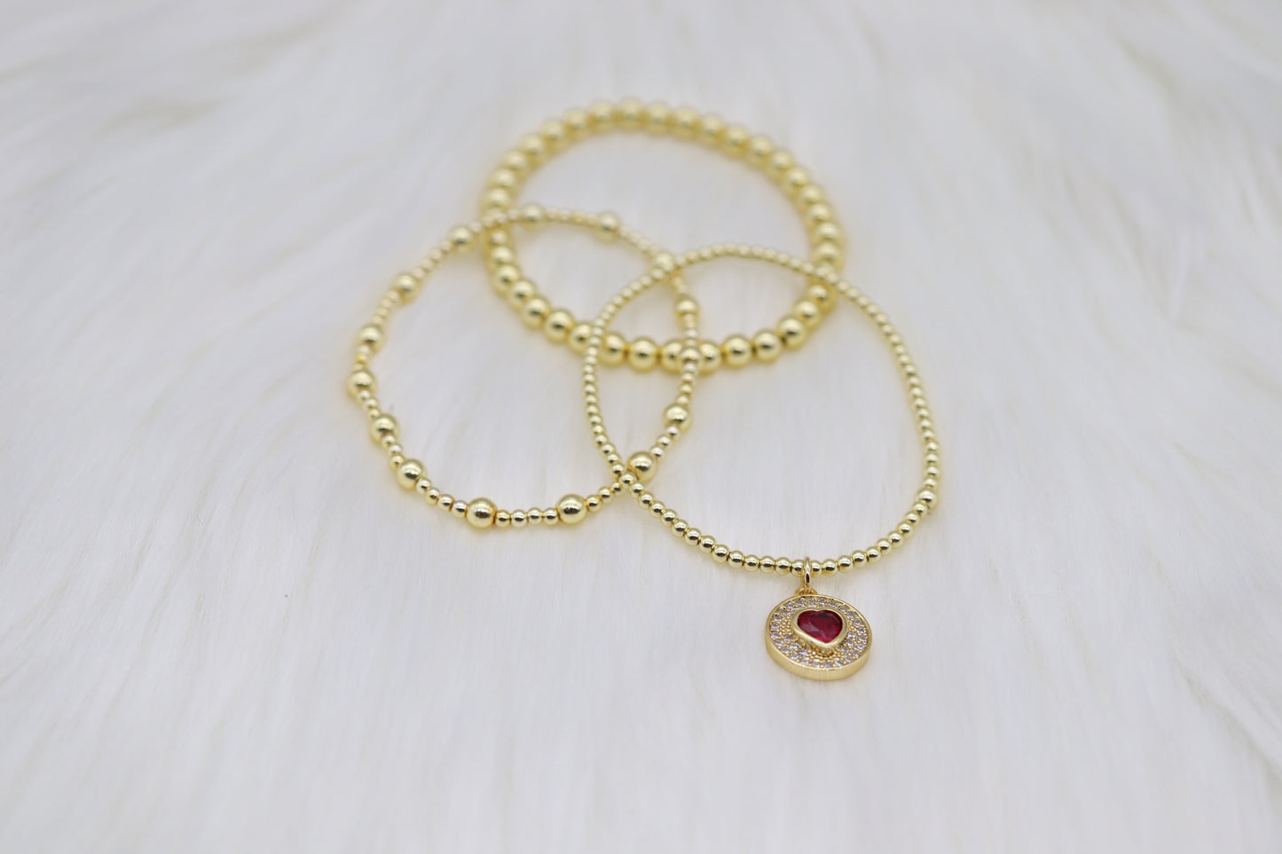 Triple Layered Gold Beaded Bracelet With Red Heart Dangling Pendant