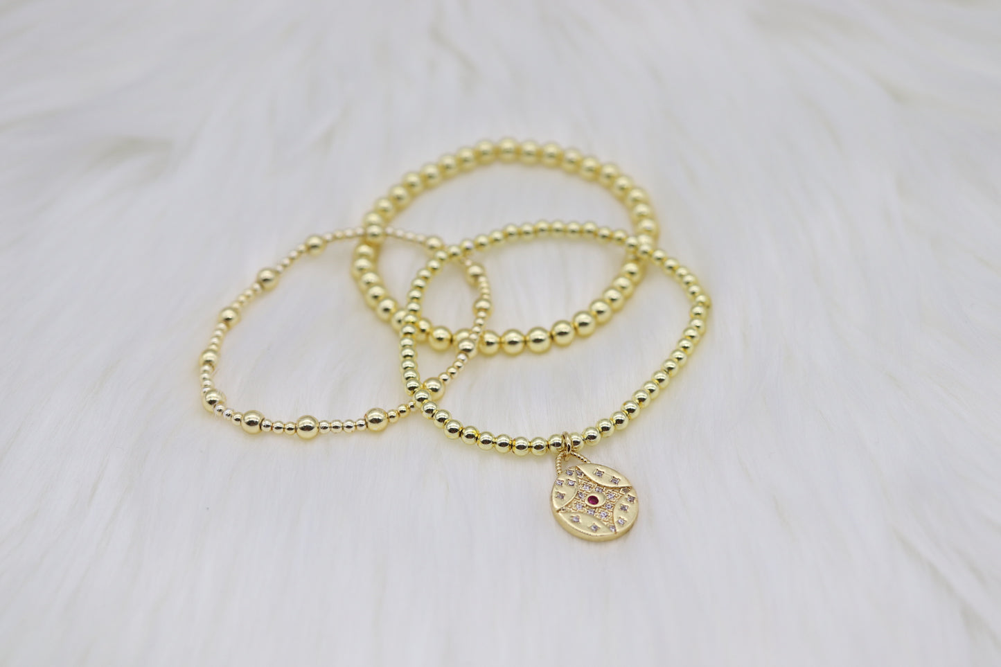 Triple Layered Gold Beaded Bracelet With Red Diamond Star Dangling Pendant