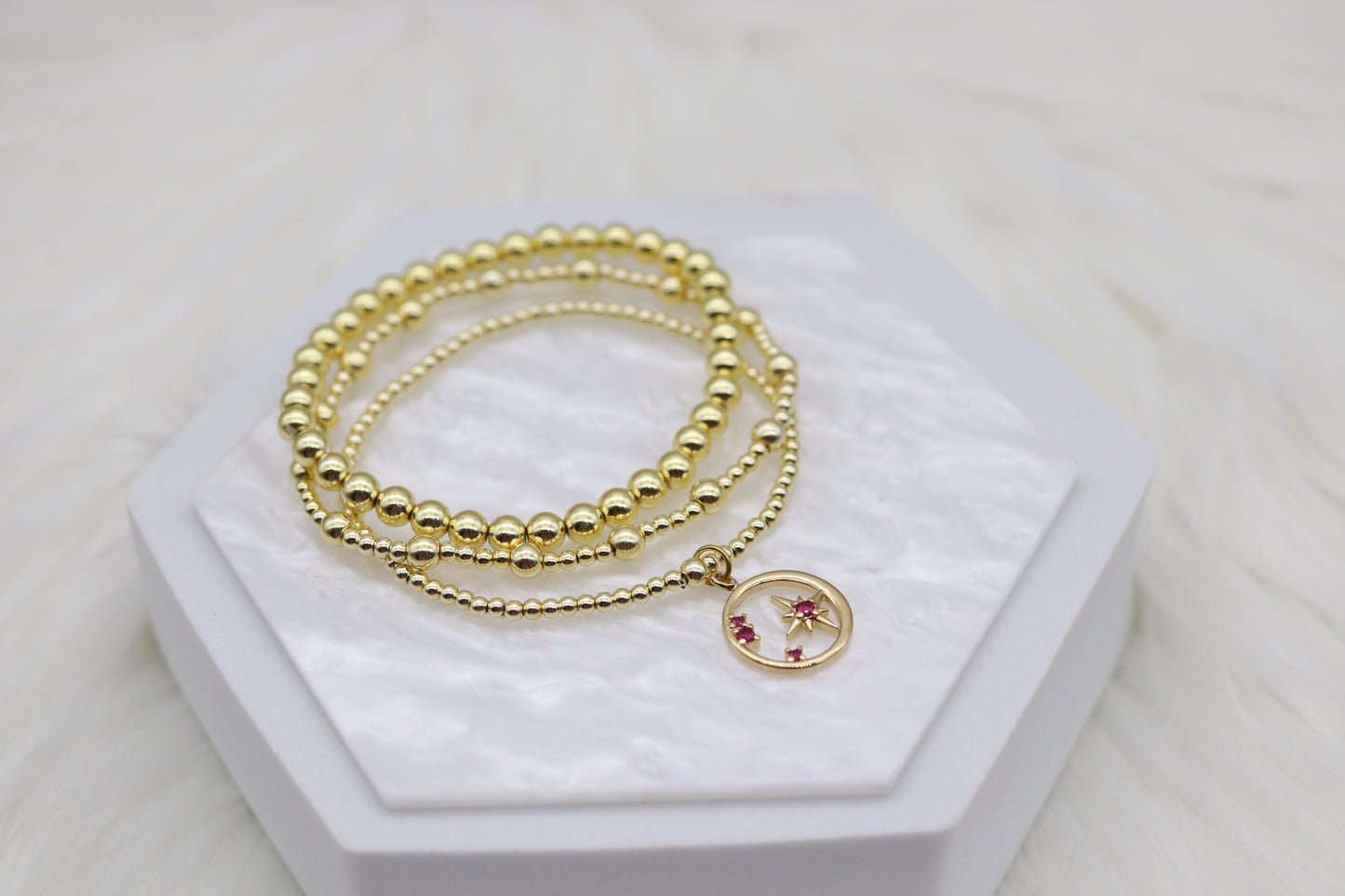 Triple Layered Gold Beaded Bracelet With Star Dangling Pendant