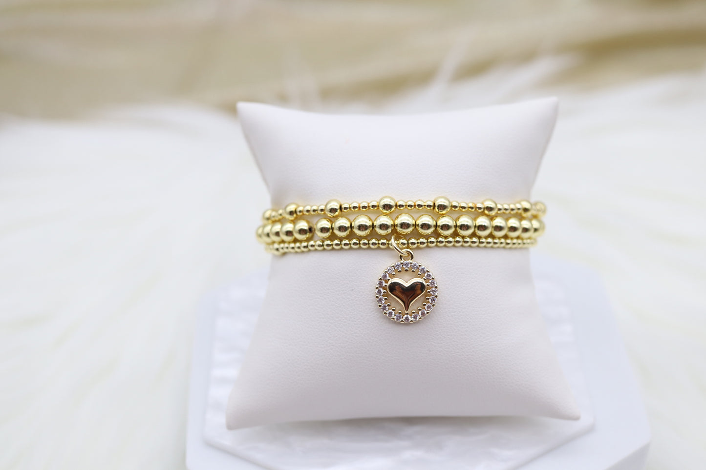 Triple Layered Gold Beaded Bracelet With Heart Dangling Pendant