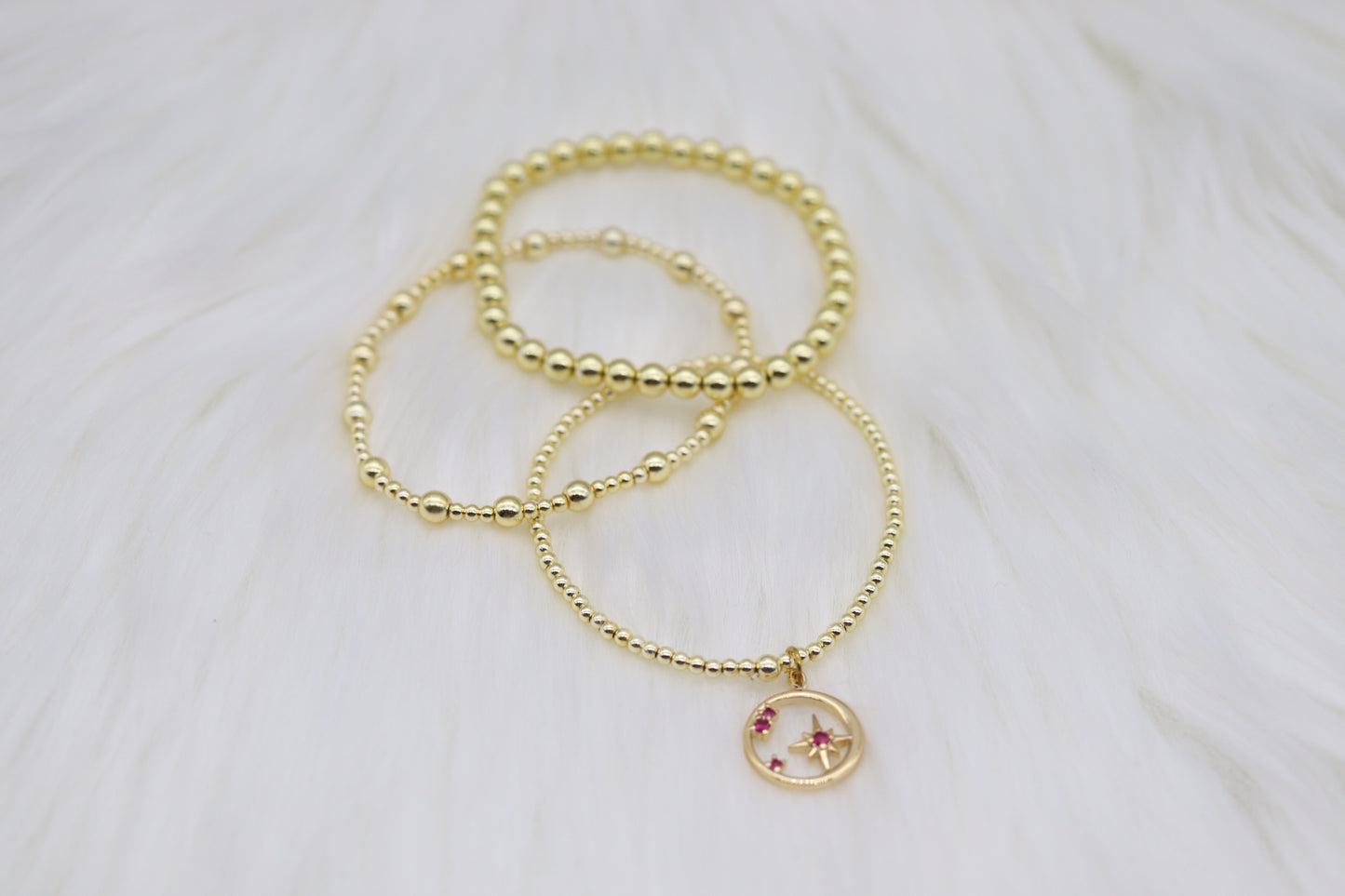 Triple Layered Gold Beaded Bracelet With Star Dangling Pendant