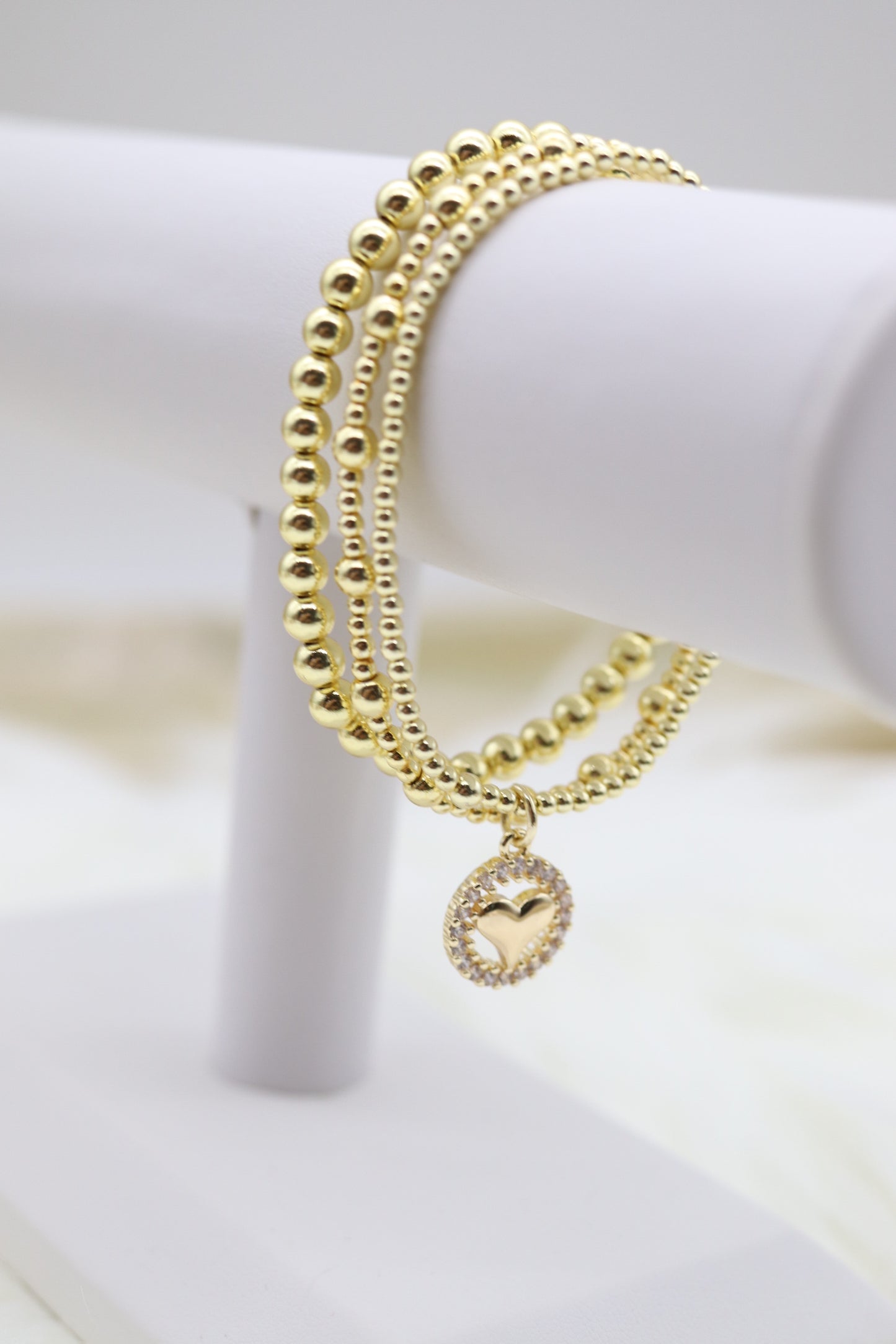 Triple Layered Gold Beaded Bracelet With Heart Dangling Pendant