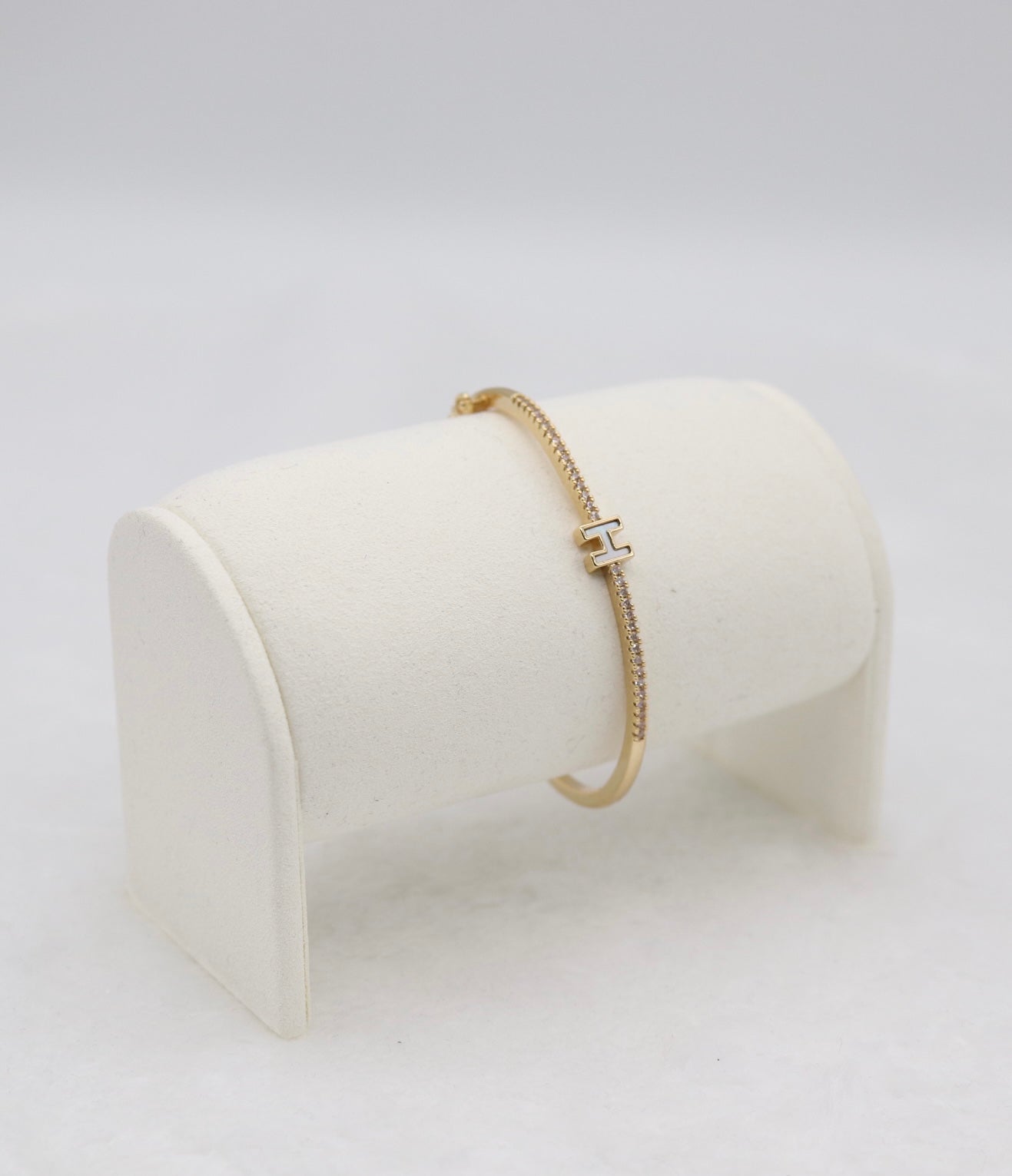 Gold-Tone Hinged Bangle with Crystal Accents and “H” Centerpiece