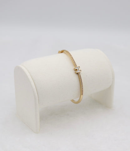 Gold-Tone Hinged Bangle with Crystal Accents and “H” Centerpiece