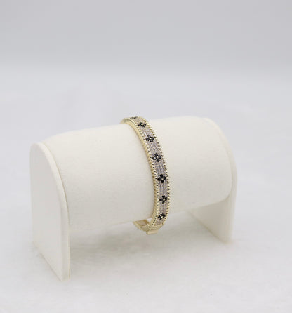 Gold-Tone Hinged Bangle with Black Floral Accents