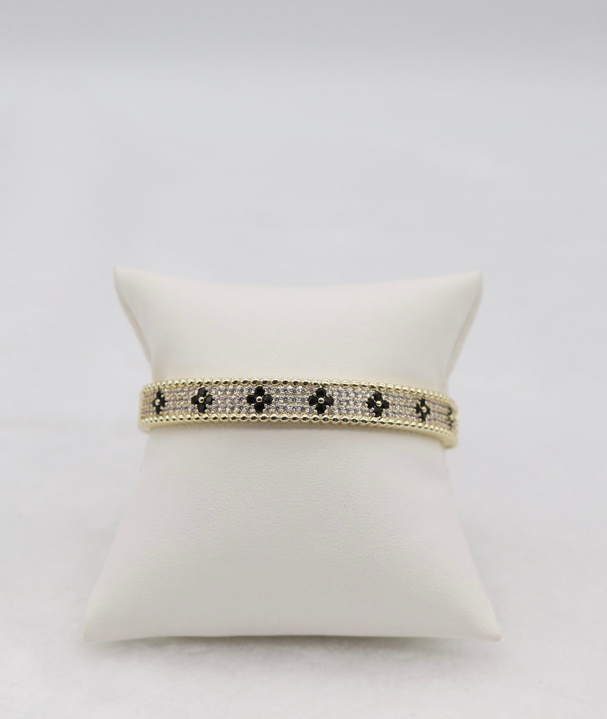 Gold-Tone Hinged Bangle with Black Floral Accents