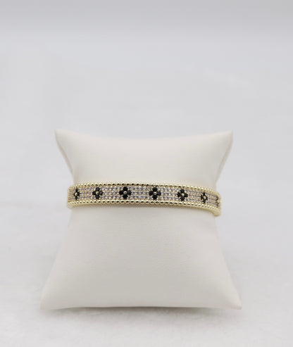 Gold-Tone Hinged Bangle with Black Floral Accents