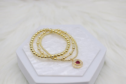 Triple Layered Gold Beaded Bracelet With Red Heart Dangling Pendant