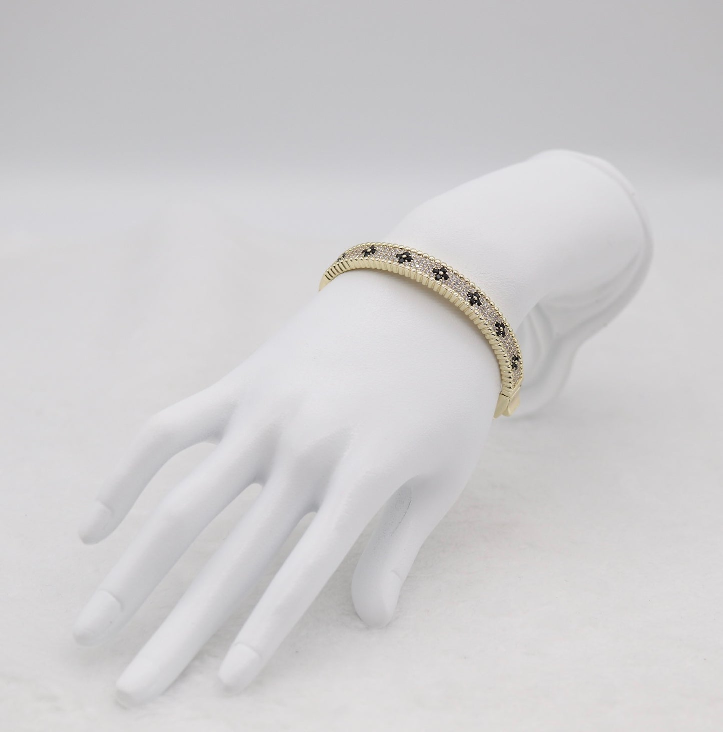 Gold-Tone Hinged Bangle with Black Floral Accents