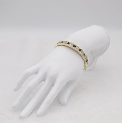 Gold-Tone Hinged Bangle with Black Floral Accents