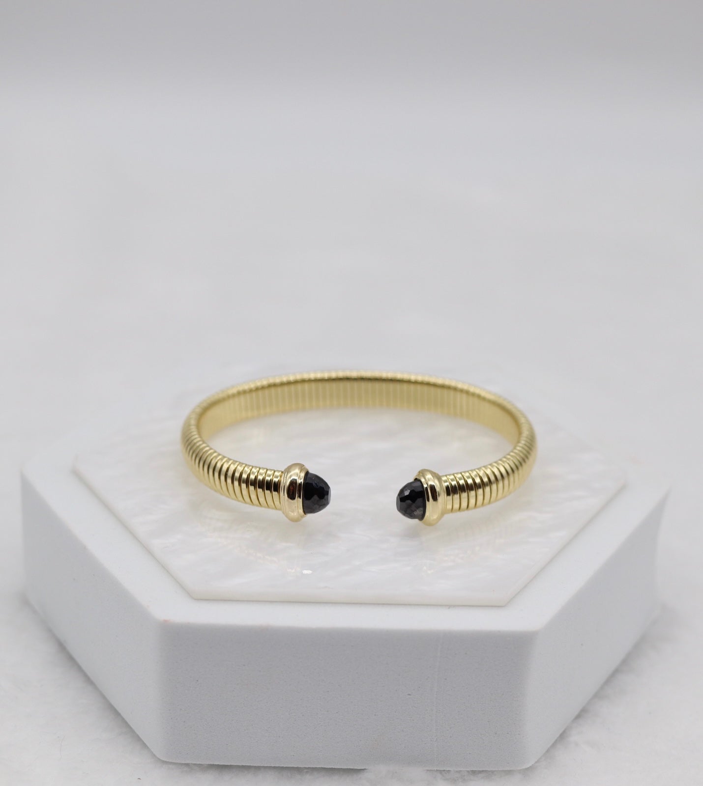 Gold Coil Cuff Bracelet with Black Gemstone Ends