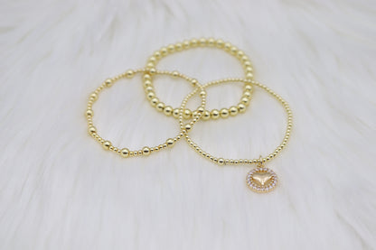 Triple Layered Gold Beaded Bracelet With Heart Dangling Pendant