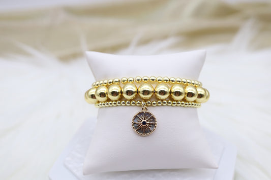 Triple Layered Gold Beaded Elastic Bracelet With Starburst Dangling Pendant