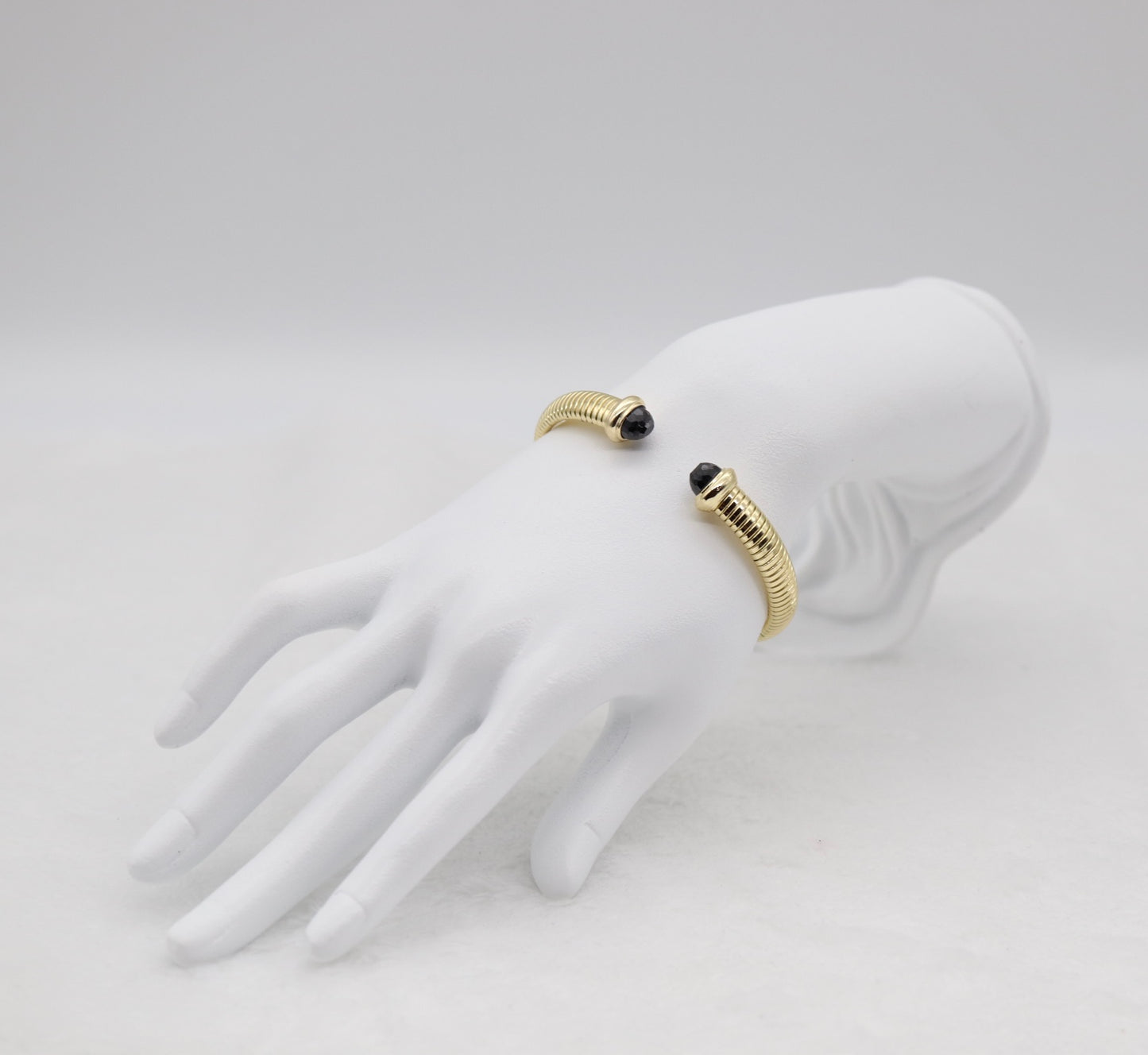 Gold Coil Cuff Bracelet with Black Gemstone Ends
