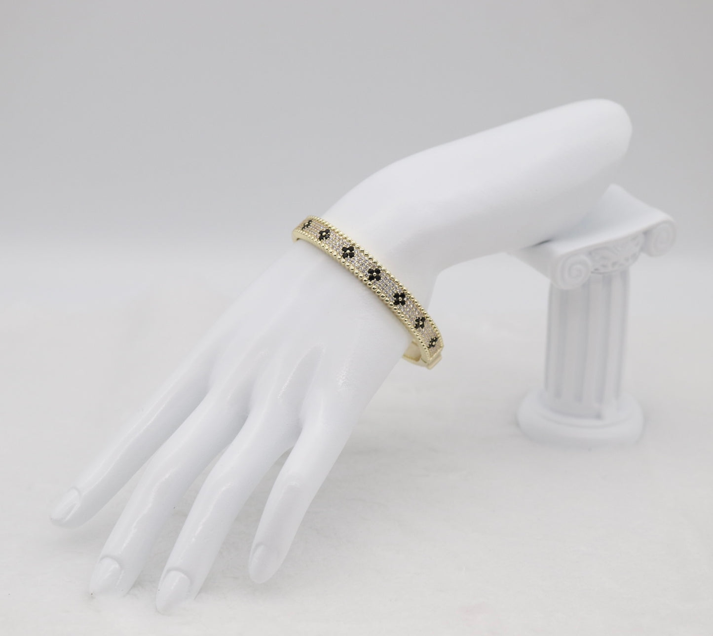 Gold-Tone Hinged Bangle with Black Floral Accents