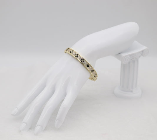 Gold-Tone Hinged Bangle with Black Floral Accents