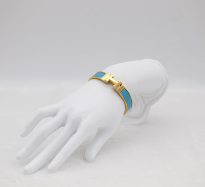 Elegant Light Blue Enamel “H” Bracelet – Gold Tone