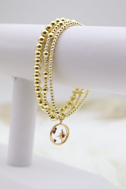 Triple Layered Gold Beaded Bracelet With Star Dangling Pendant