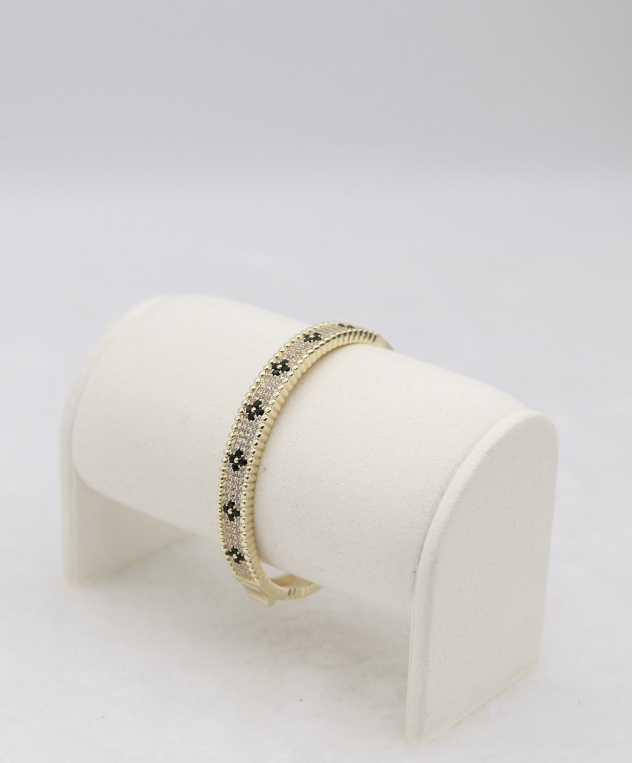 Gold-Tone Hinged Bangle with Black Floral Accents