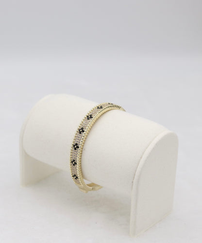 Gold-Tone Hinged Bangle with Black Floral Accents