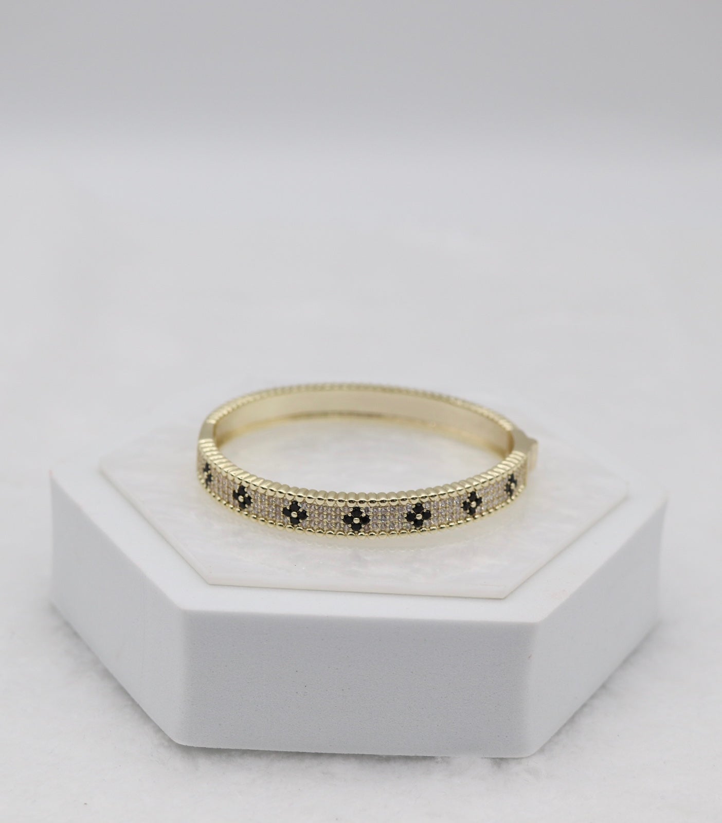 Gold-Tone Hinged Bangle with Black Floral Accents