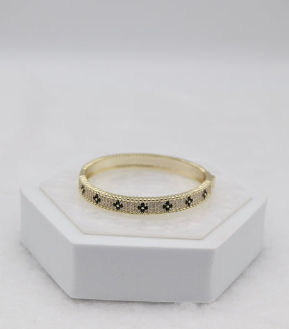 Gold-Tone Hinged Bangle with Black Floral Accents