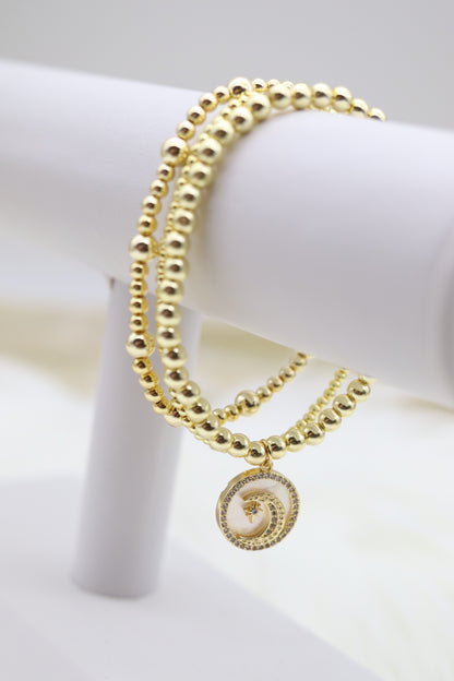 Triple Layered Gold Beaded Bracelet With Half Moon Dangling Pendant