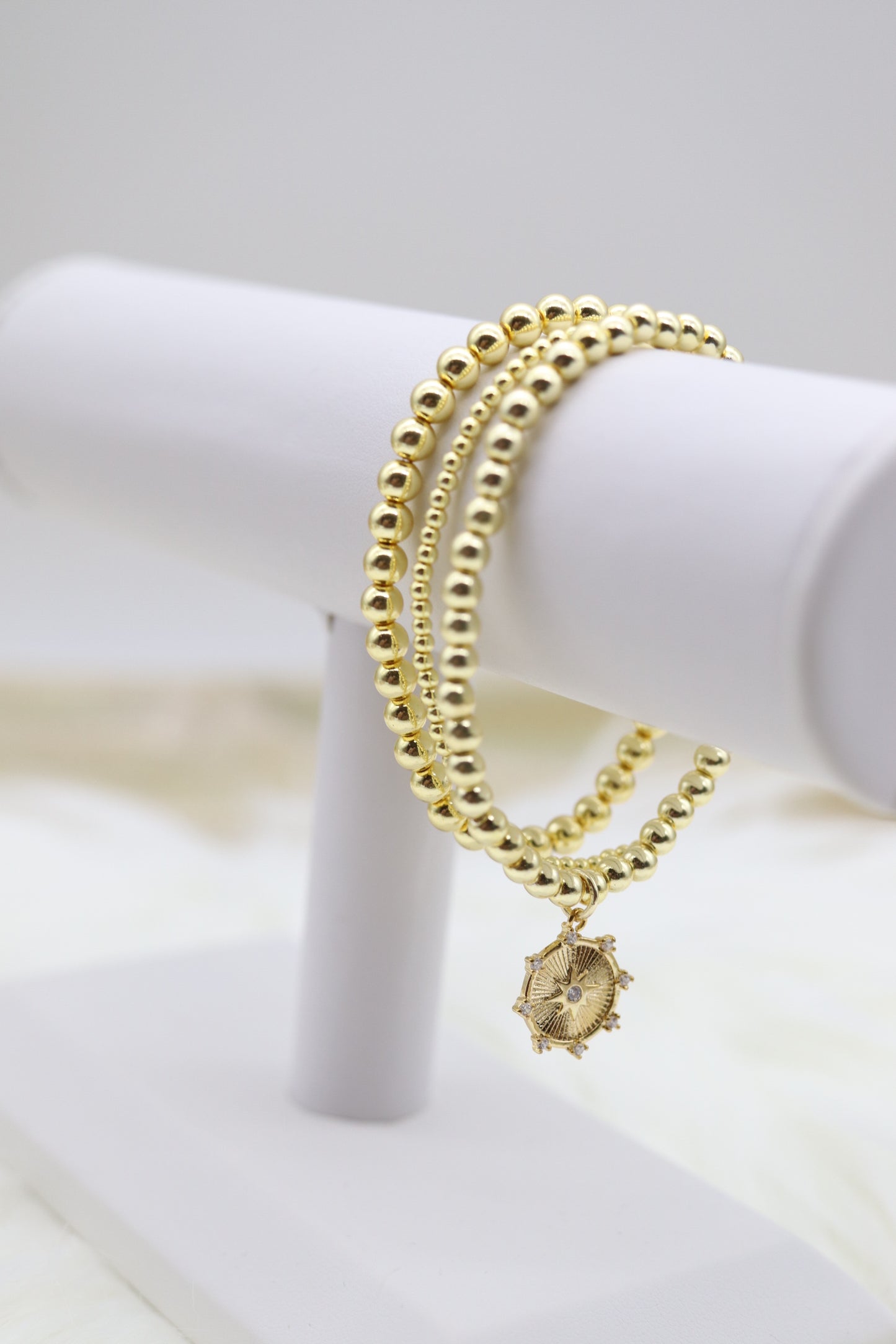 Triple Layered Gold Beaded Bracelet With Diamond Star Dangling Pendant