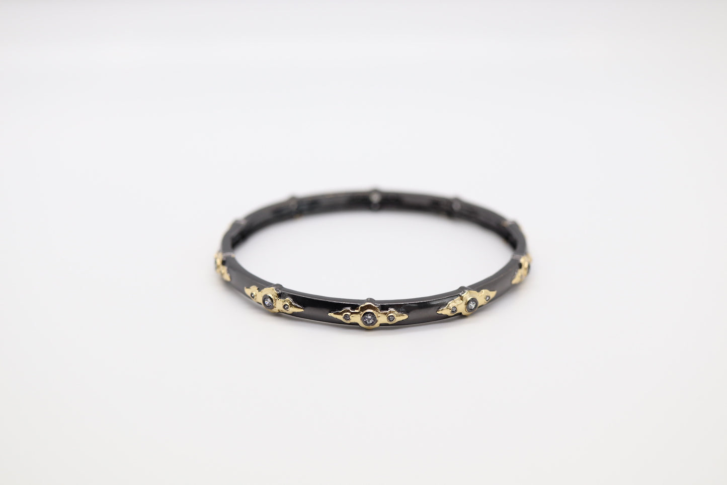 Coal Black Bangle with Gold Shape Stations Trim with Crystals