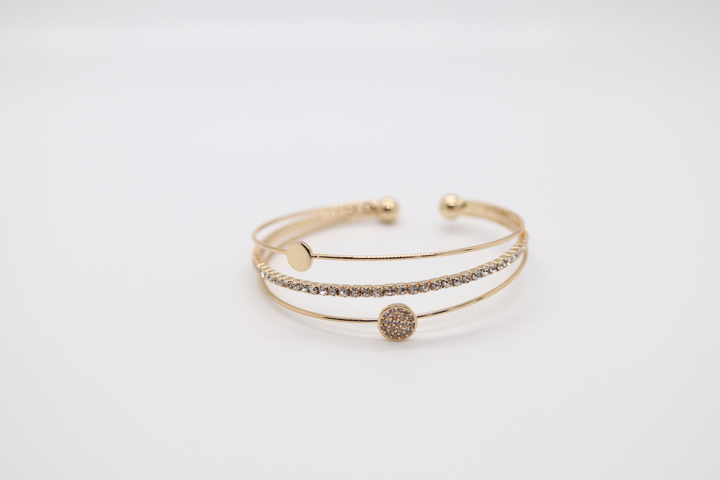 Triple Strand Gold Cuff Bracelet with Parvee Circle and Single Row of Crystals in the Middle.