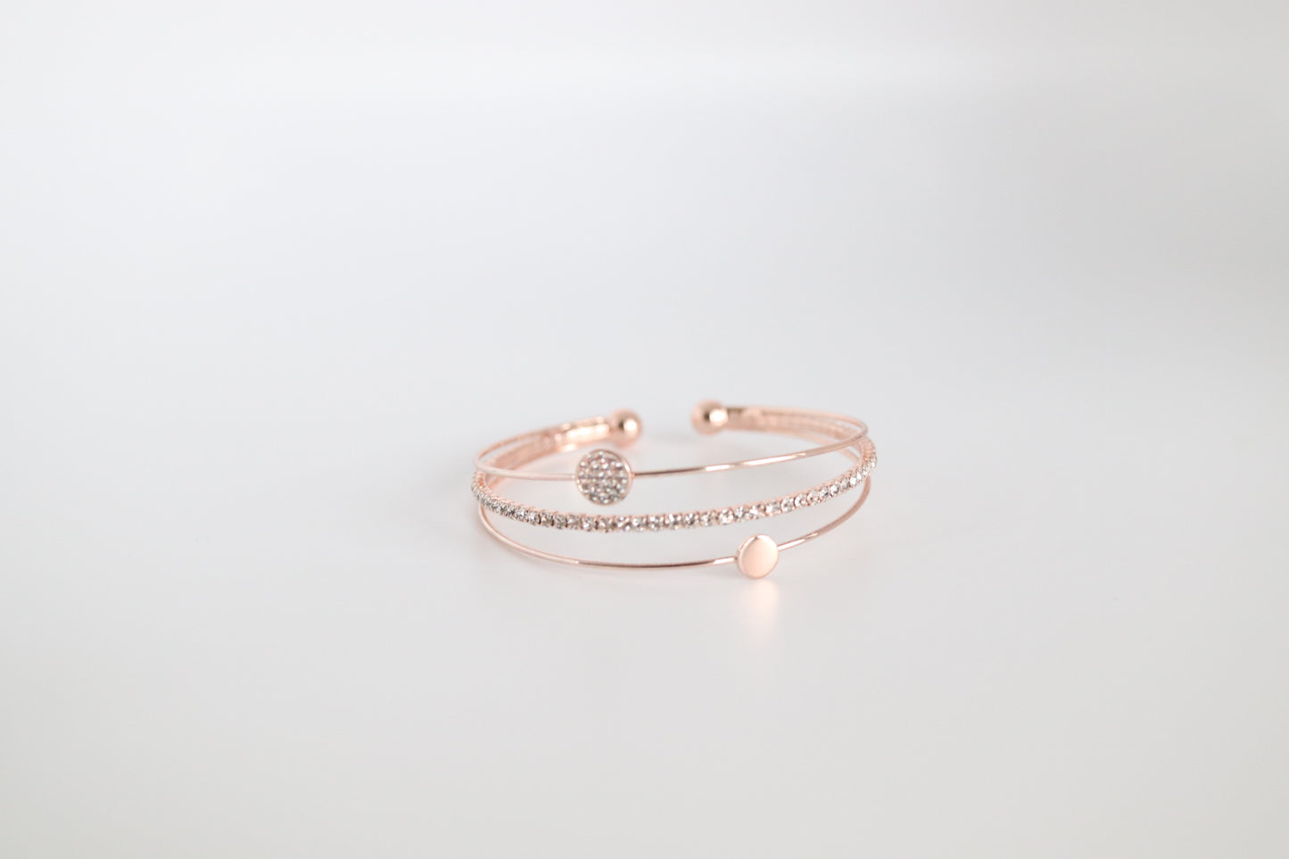 Triple Strand Rose Gold Cuff Bracelet with Parvee Circle and Single Row of Crystals in the Middle.